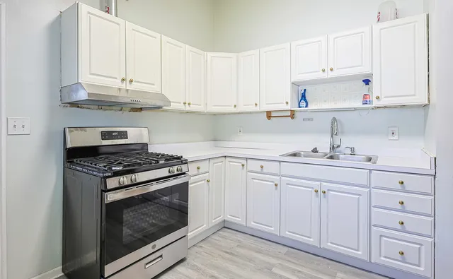 a kitchen with cabinets appliances and a sink