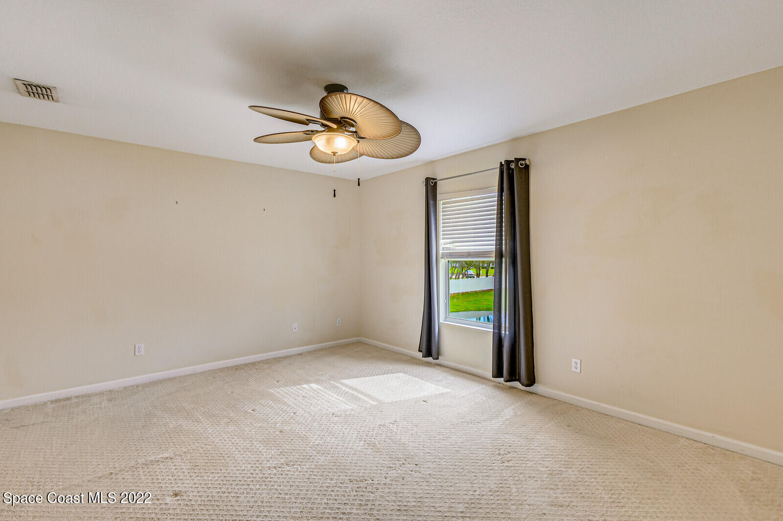 2765 Revolution Street, Unit 101 Melbourne, FL 32935 - Photo 14 of 48 a view of an empty room with a window