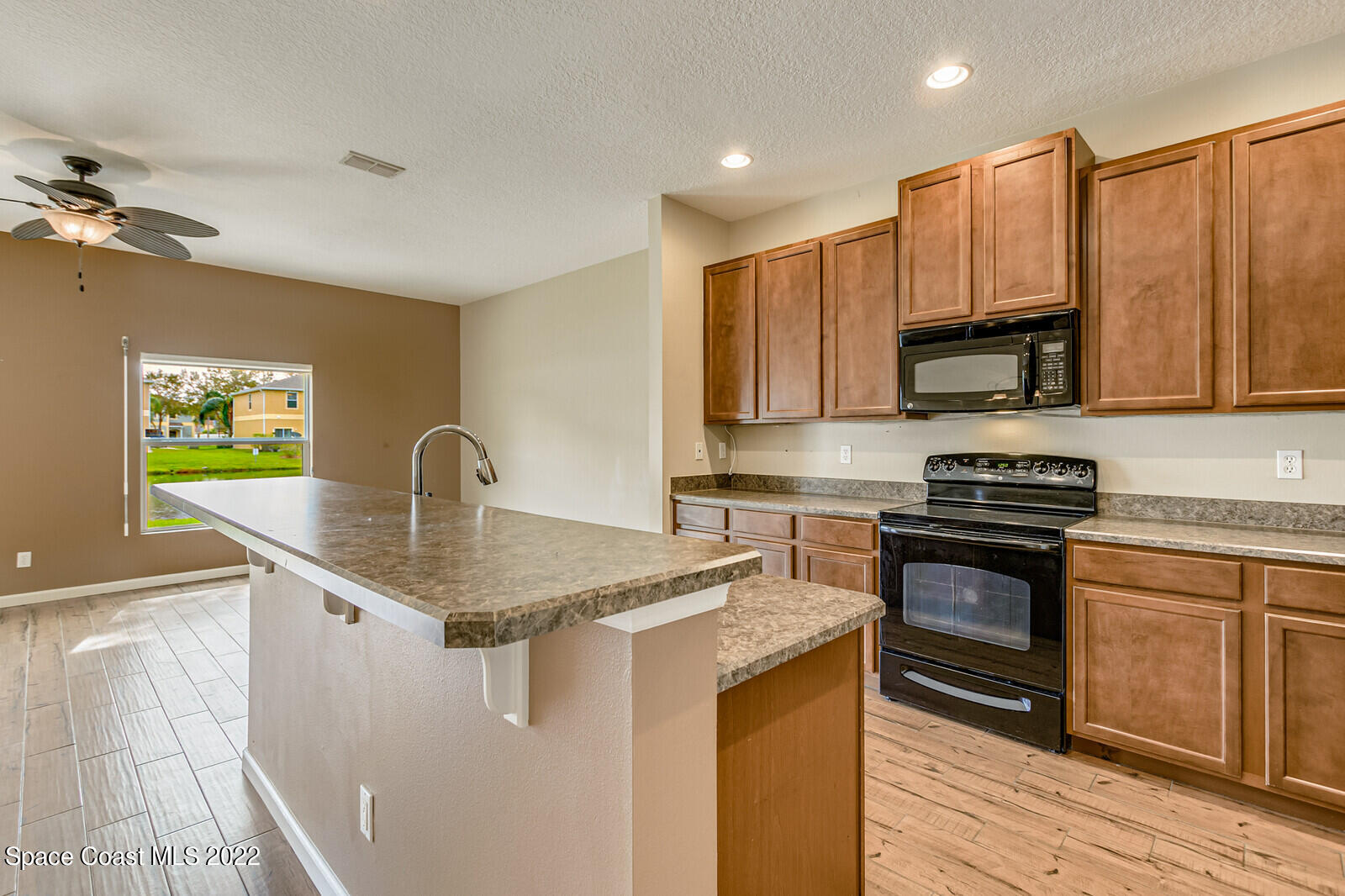 2765 Revolution Street, Unit 101 Melbourne, FL 32935 - Photo 3 of 48 a kitchen with stainless steel appliances granite countertop a sink a stove and a refrigerator