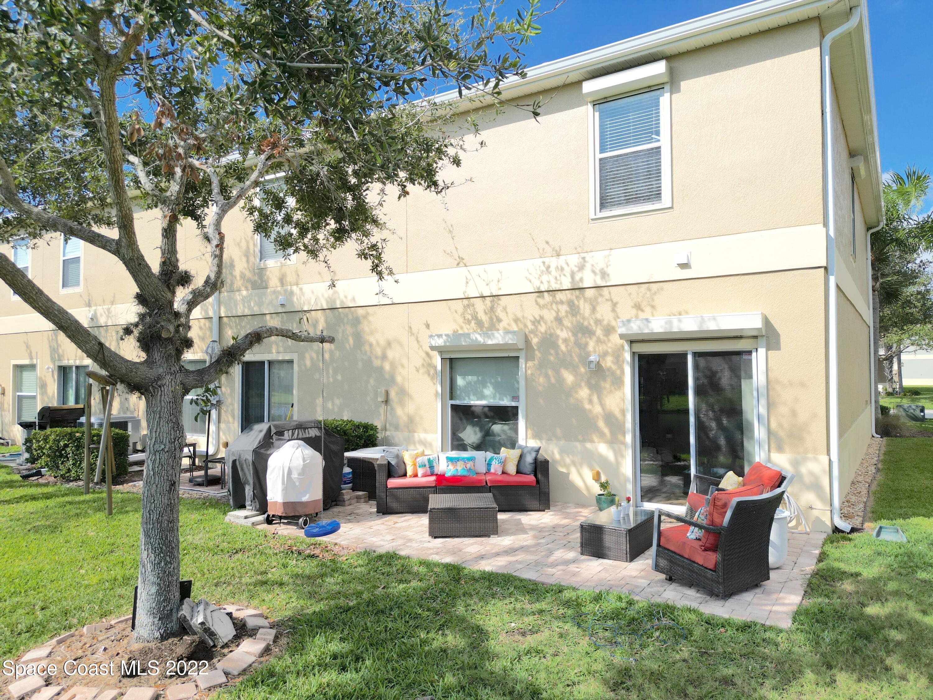 2765 Revolution Street, Unit 101 Melbourne, FL 32935 - Photo 32 of 48 a view of a house with backyard porch and sitting area