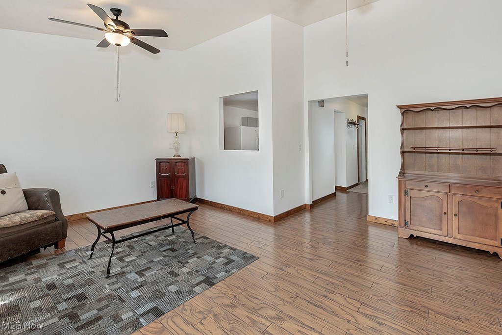 6881 Lake Road Medina, OH 44256 - Photo 6 of 34 Living room with a towering ceiling, dark wood-style flooring, baseboards, and ceiling fan