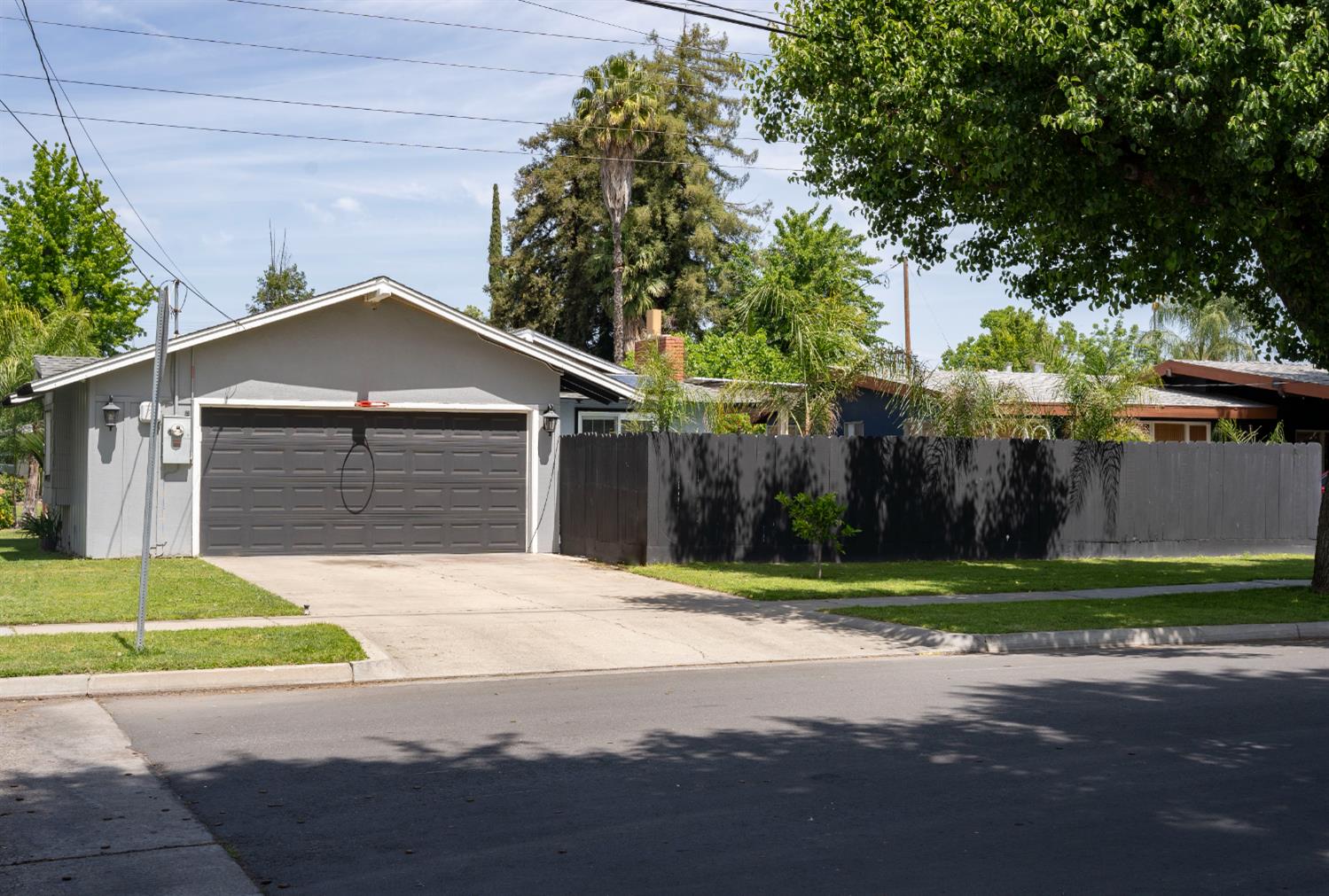 3662 North Angus Street Fresno, CA 93726 - Photo 12 of 67 a front view of a house with a yard and garage