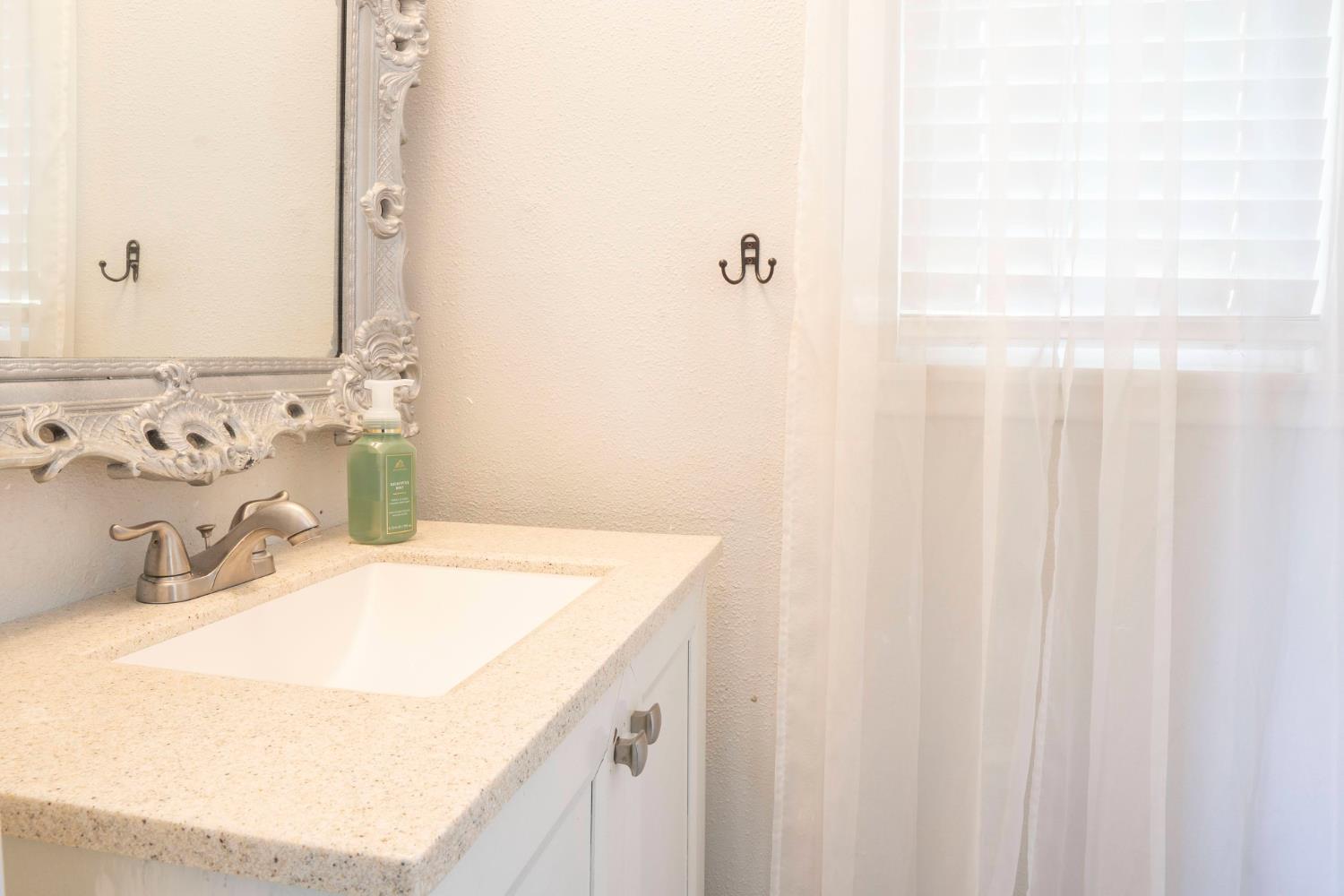 3662 North Angus Street Fresno, CA 93726 - Photo 27 of 67 a bathroom with a sink and a mirror