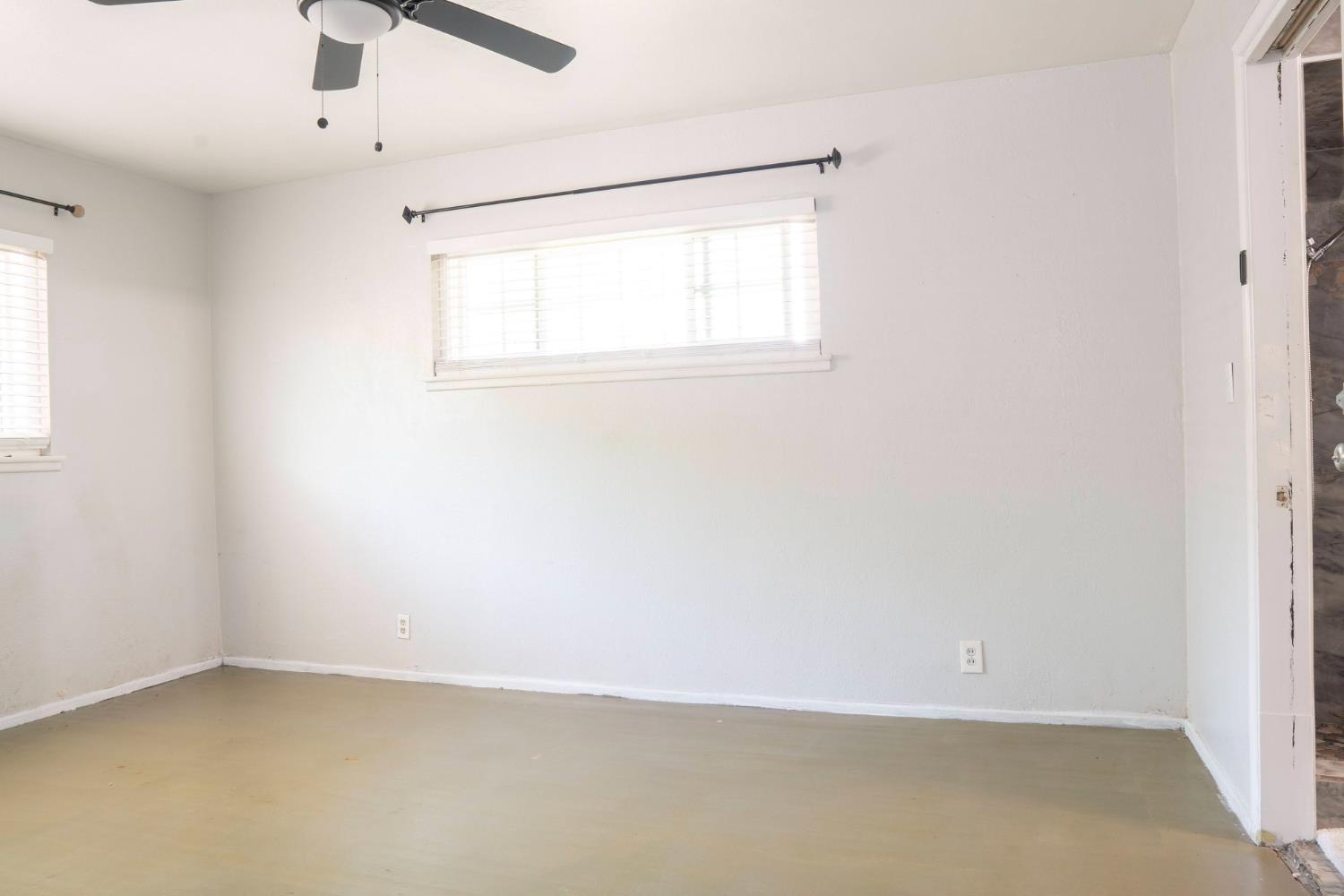 3662 North Angus Street Fresno, CA 93726 - Photo 33 of 67 an empty room with a window and a ceiling fan