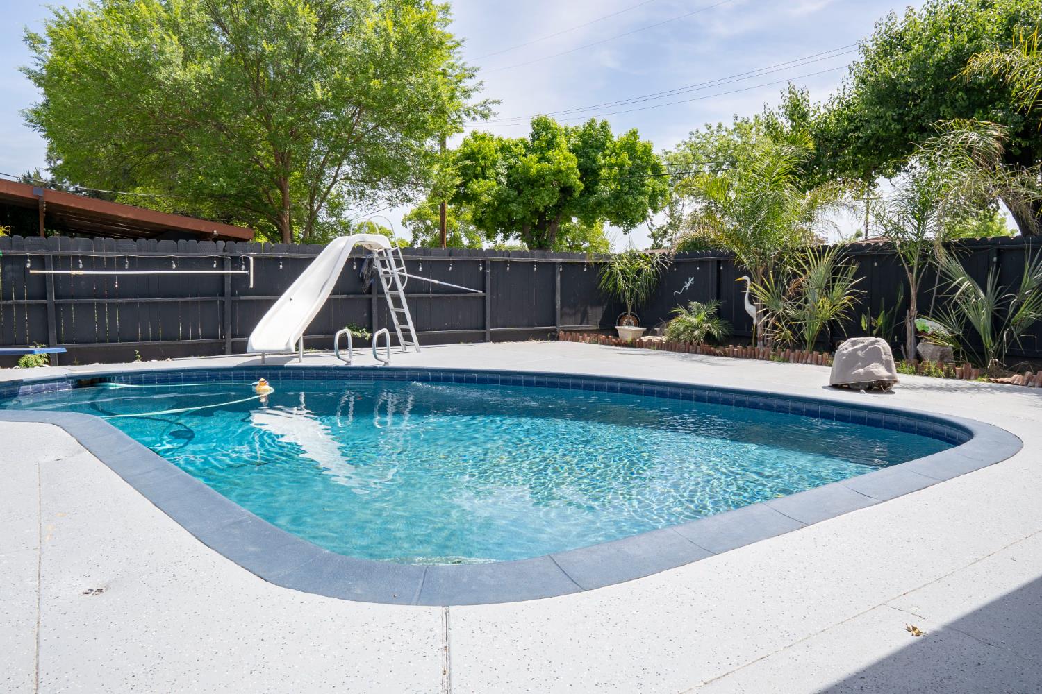 3662 North Angus Street Fresno, CA 93726 - Photo 43 of 67 a view of a swimming pool with a yard