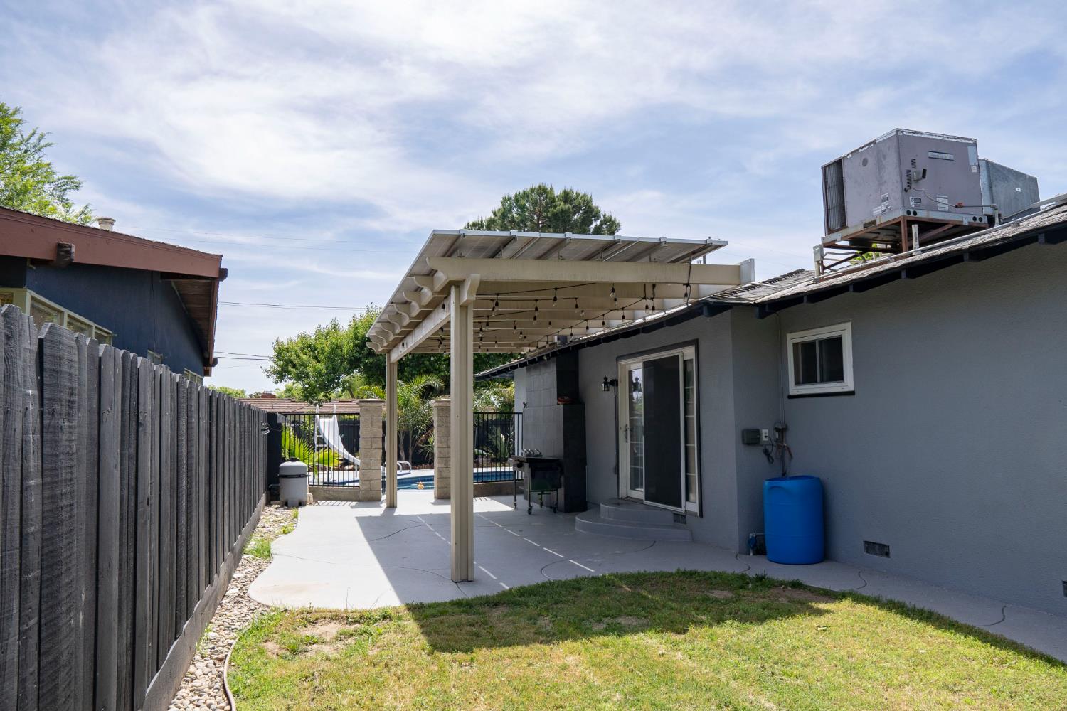 3662 North Angus Street Fresno, CA 93726 - Photo 54 of 67 a swimming pool with barbeque oven and potted plants