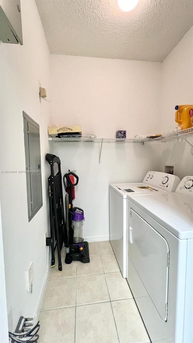 2727 Anzio Court, Unit 106 Palm Beach Gardens, FL 33410 - Photo 11 of 43 a utility room with dryer and washer