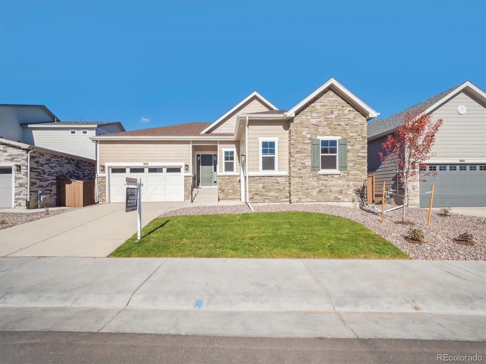 9178 Gold Lace Place Littleton, CO 80129 - Photo 1 of 26 a front view of a house with a yard and garage