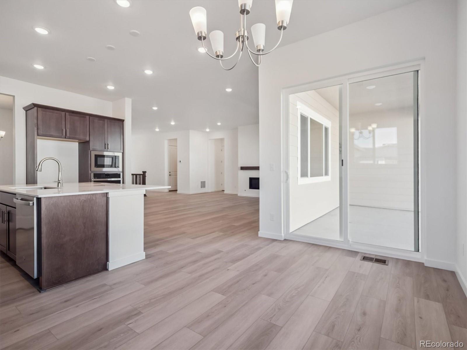 9178 Gold Lace Place Littleton, CO 80129 - Photo 11 of 26 a view of a kitchen and a kitchen with electric equipment