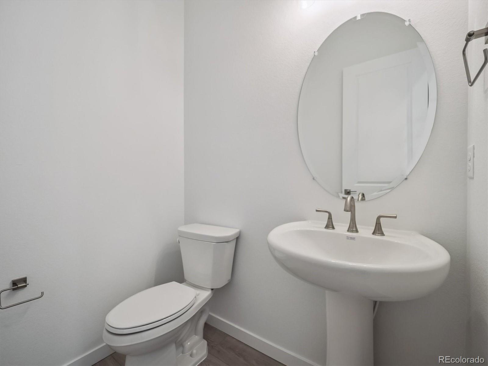 9178 Gold Lace Place Littleton, CO 80129 - Photo 6 of 26 a bathroom with a toilet sink and mirror
