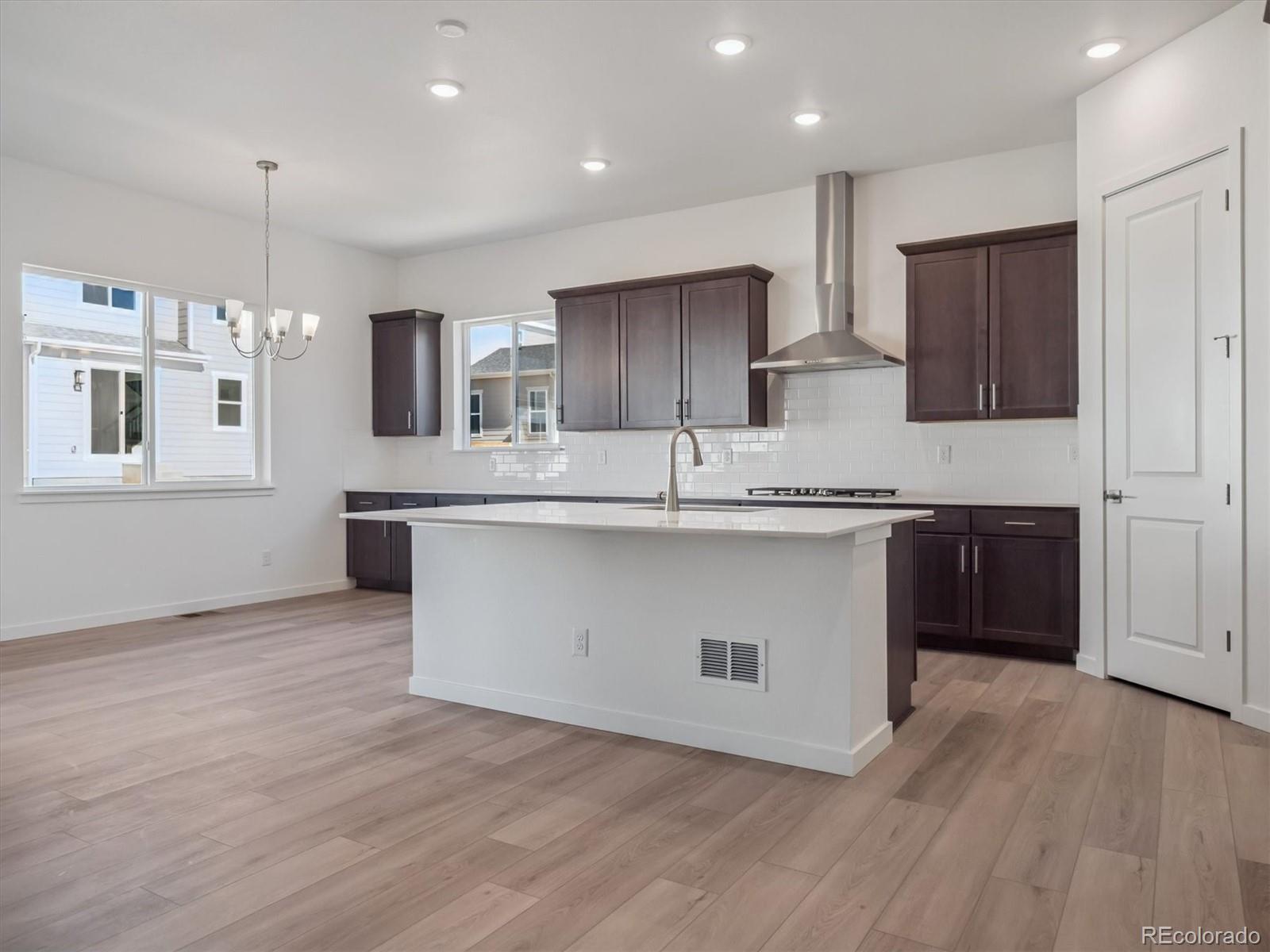 9178 Gold Lace Place Littleton, CO 80129 - Photo 10 of 26 a large kitchen with stainless steel appliances granite countertop a large counter top a sink and a stove