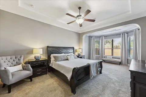 a bedroom with a large bed and a couch