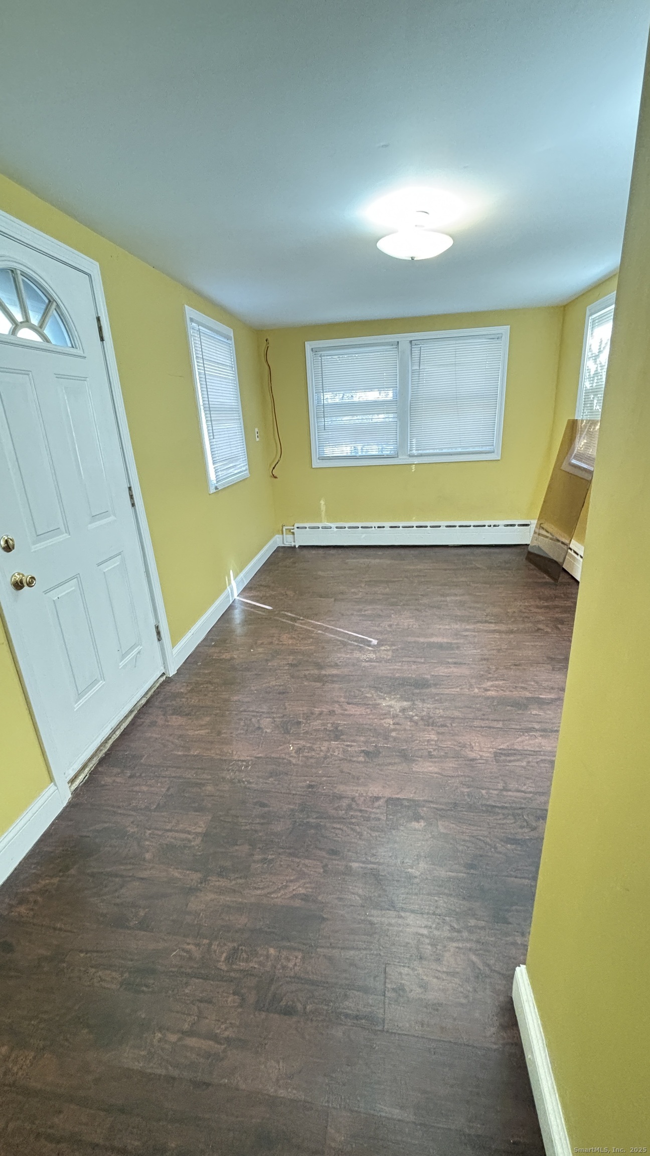 341 Oak Street Waterbury, CT 06705 - Photo 13 of 34 a view of empty room with window and wooden floor