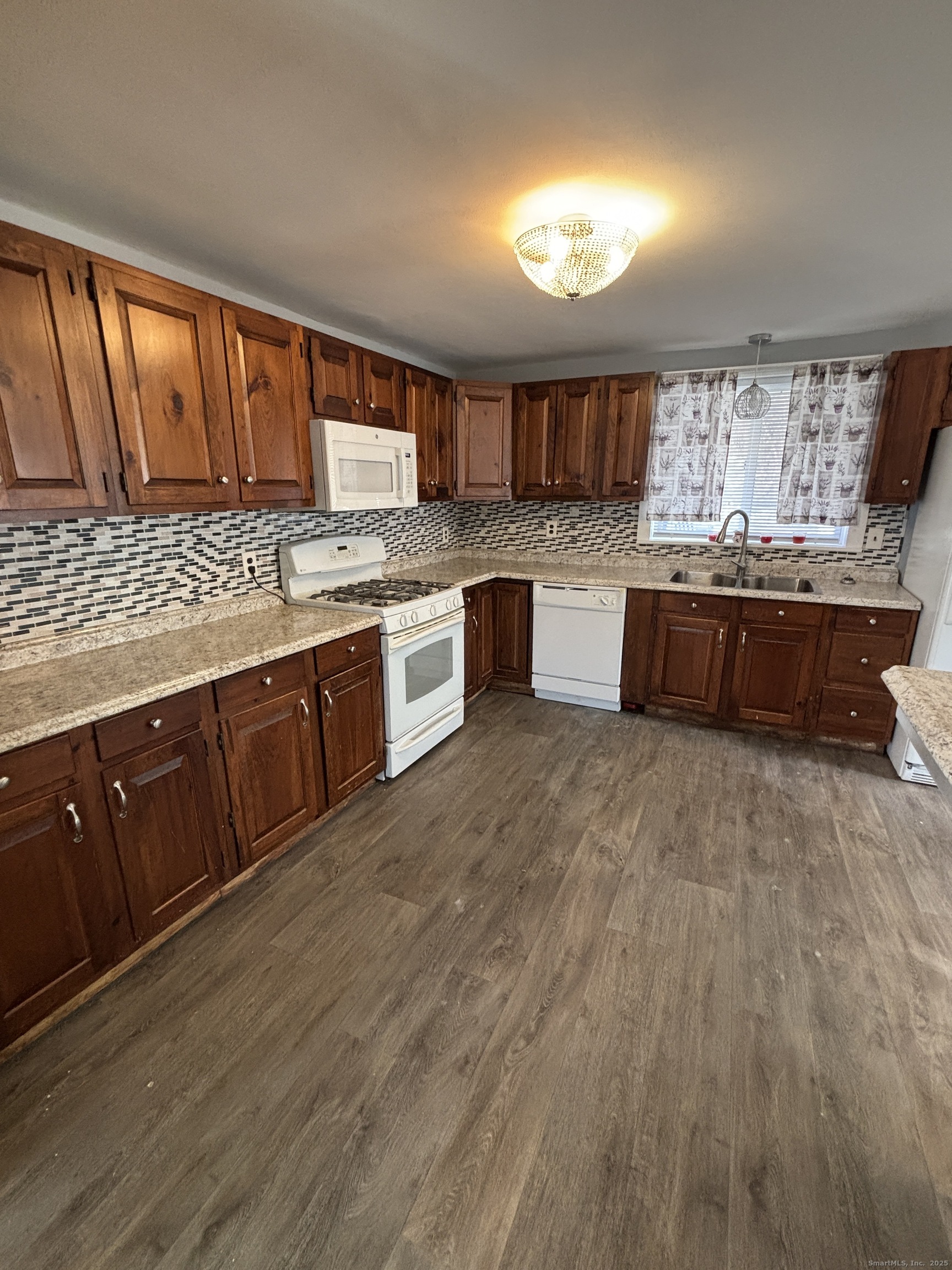 341 Oak Street Waterbury, CT 06705 - Photo 19 of 34 a large kitchen with lots of counter space and wooden floor