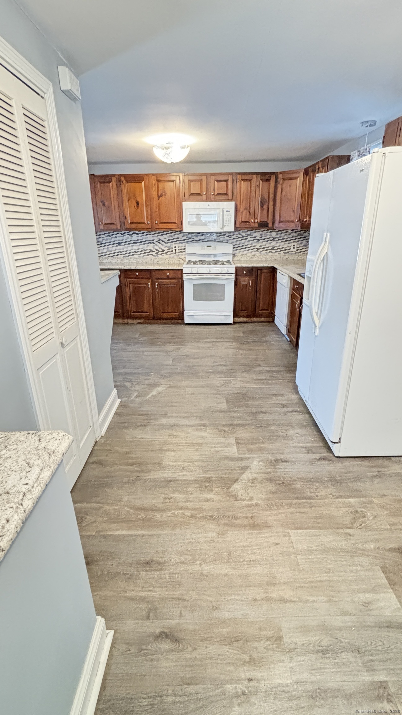 341 Oak Street Waterbury, CT 06705 - Photo 27 of 34 a view of kitchen and wooden floor