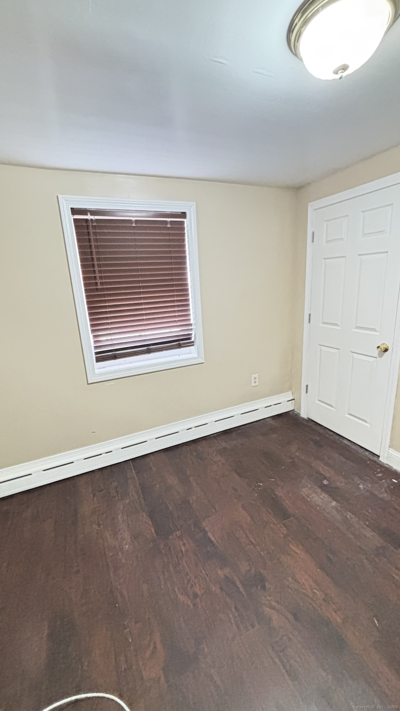 341 Oak Street Waterbury, CT 06705 - Photo 31 of 34 an empty room with wooden floor and windows