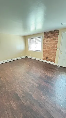 a bathroom with a toilet a sink a mirror and a shower