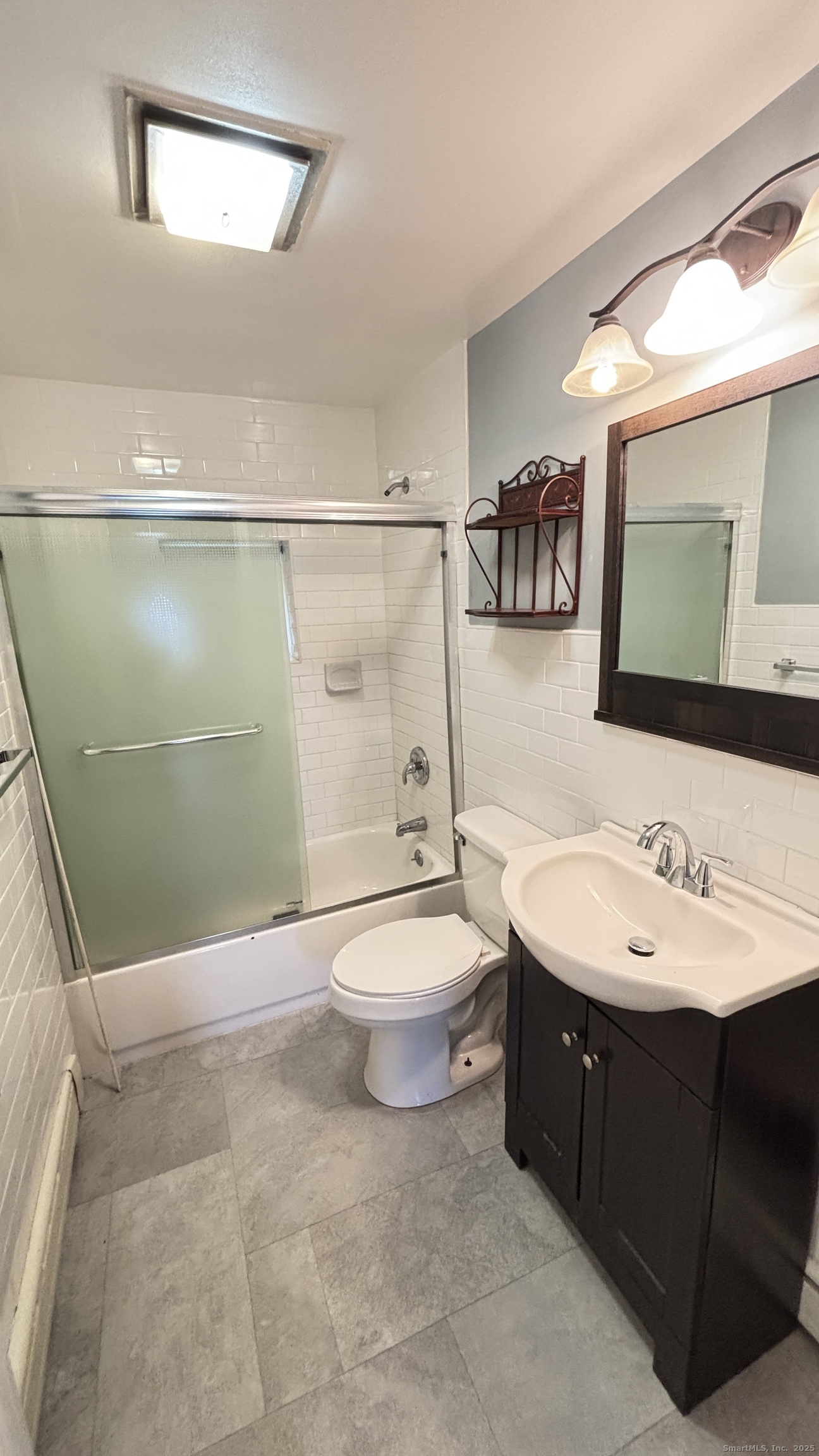 341 Oak Street Waterbury, CT 06705 - Photo 33 of 34 a bathroom with a toilet a sink a mirror and a shower