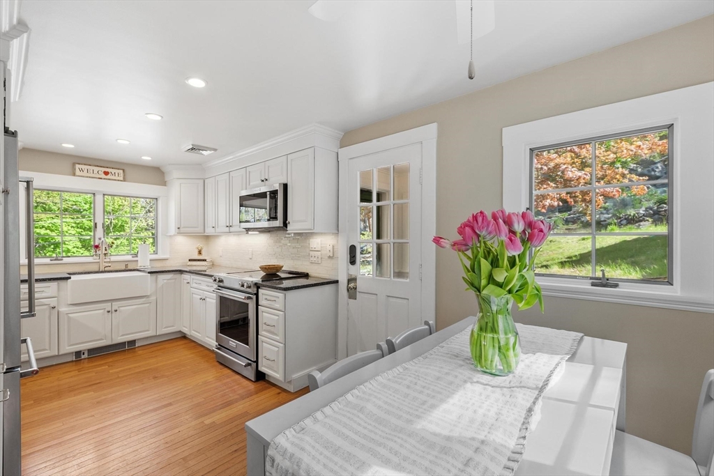 25 Naples Road Melrose, MA 02176 - Photo 14 of 36 a kitchen with granite countertop stainless steel appliances stove sink and white cabinets