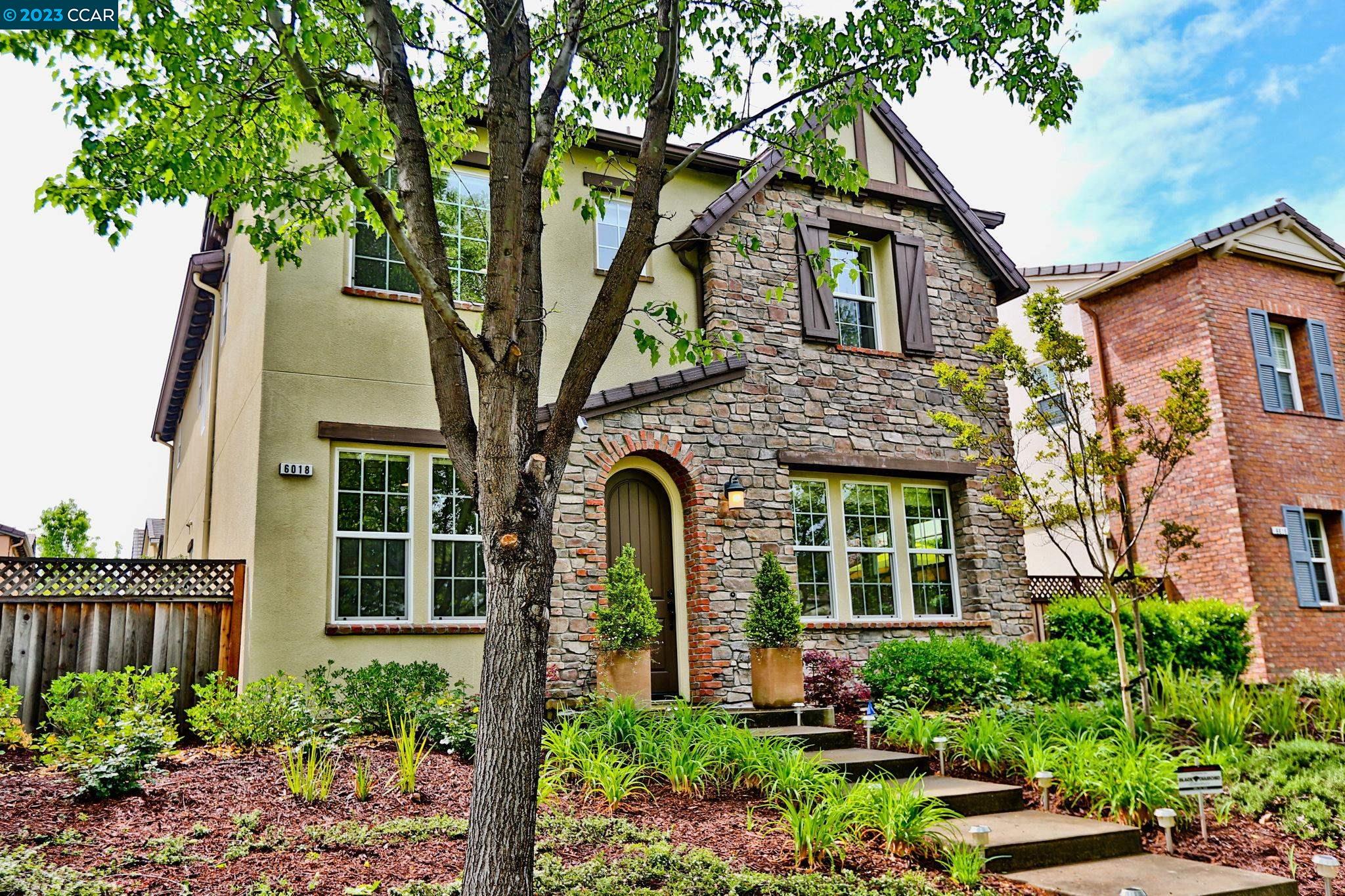 a front view of a house with a garden