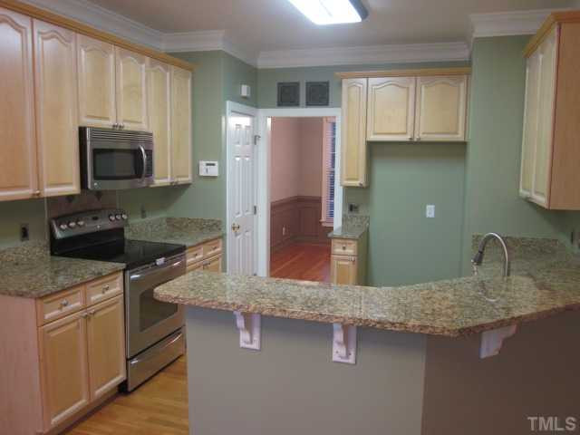 10024 Baileywick Road Raleigh, NC 27613 - Photo 13 of 25 Kitchen updates two years new! Granite counter tops, stainless steel appliances, warming drawer on bottom of oven, built in microwave, roll outs and pantry! Kitchen