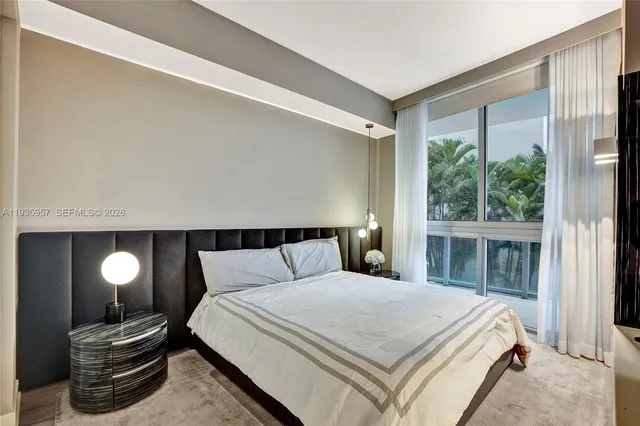 a bedroom with bed and glass door