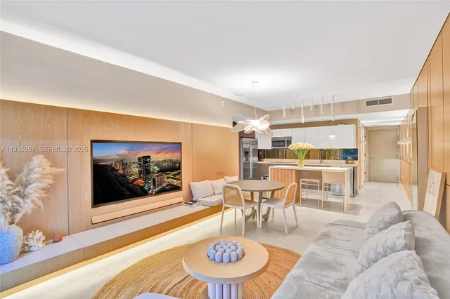 a living room with furniture and kitchen view