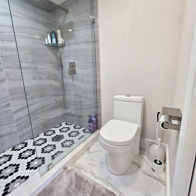 1705 Andros Isle, Unit C3 Coconut Creek, FL 33066 - Photo 17 of 36 a bathroom with a toilet and a shower
