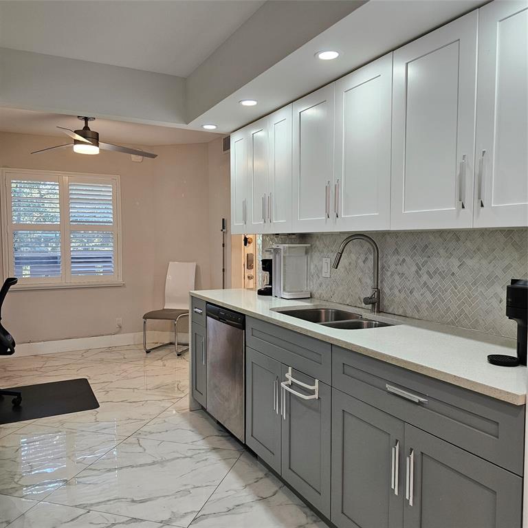 1705 Andros Isle, Unit C3 Coconut Creek, FL 33066 - Photo 25 of 36 a kitchen with a sink and cabinets