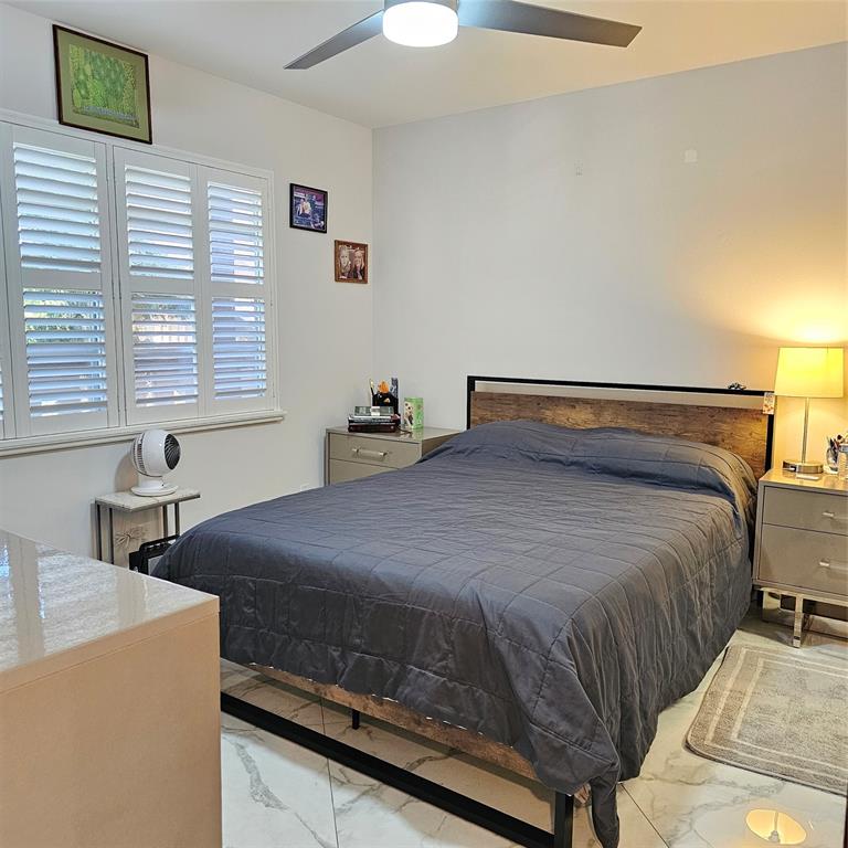 1705 Andros Isle, Unit C3 Coconut Creek, FL 33066 - Photo 32 of 36 a bedroom with a bed and a lamp