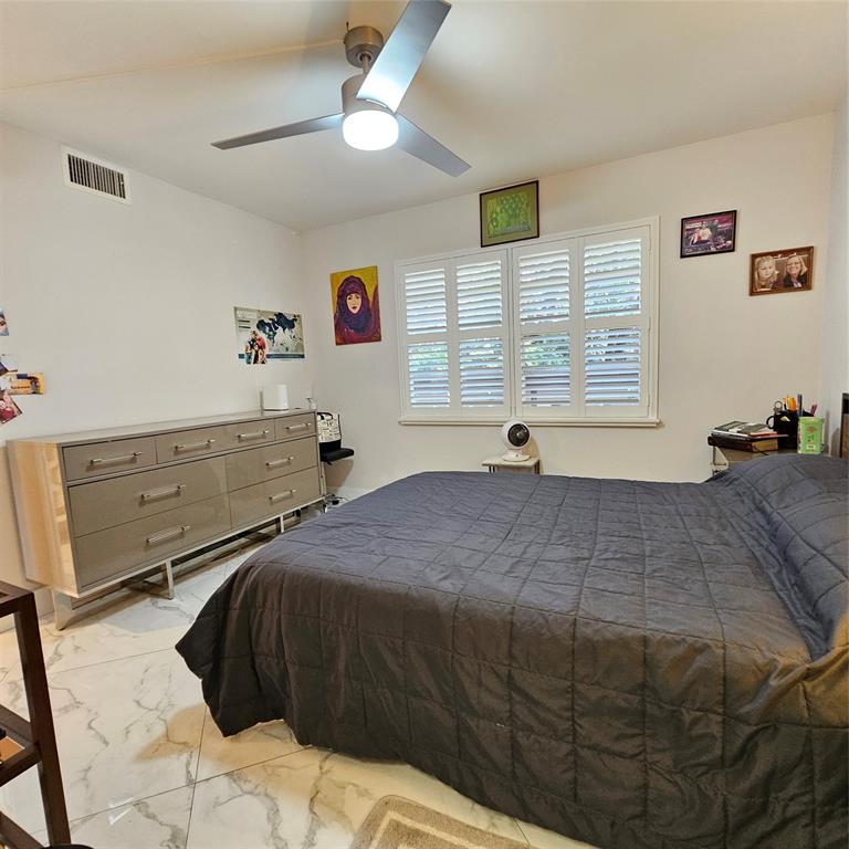 1705 Andros Isle, Unit C3 Coconut Creek, FL 33066 - Photo 33 of 36 a bedroom with a bed and a window