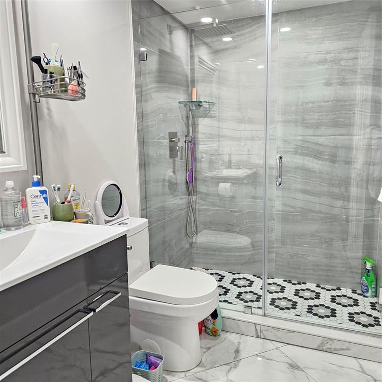 1705 Andros Isle, Unit C3 Coconut Creek, FL 33066 - Photo 34 of 36 a bathroom with a sink toilet and shower