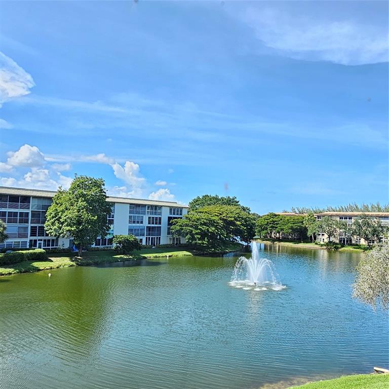 1705 Andros Isle, Unit C3 Coconut Creek, FL 33066 - Photo 36 of 36 a view of a lake with houses in the back