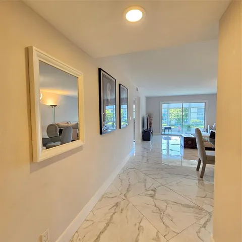 a view of a livingroom with furniture and a window