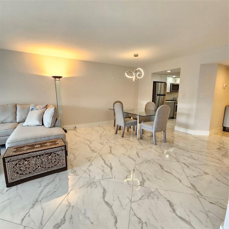 1705 Andros Isle, Unit C3 Coconut Creek, FL 33066 - Photo 8 of 36 a living room with a couch and a table