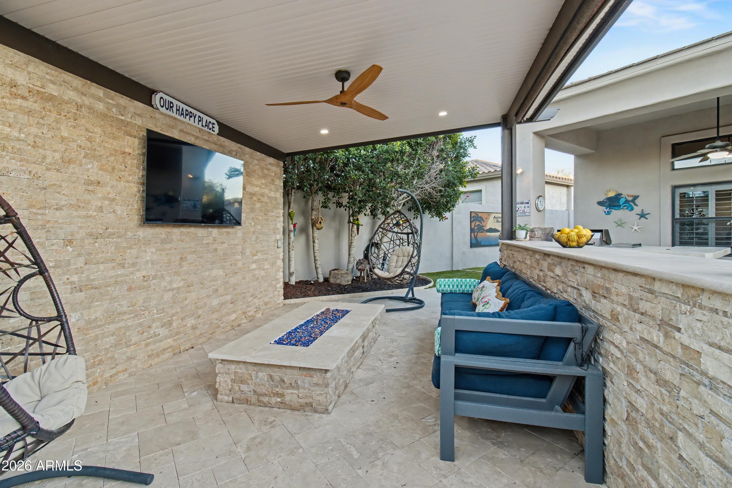 2184 West Weatherby Way Chandler, AZ 85286 - Photo 11 of 60 a living room with fireplace furniture and a flat screen tv