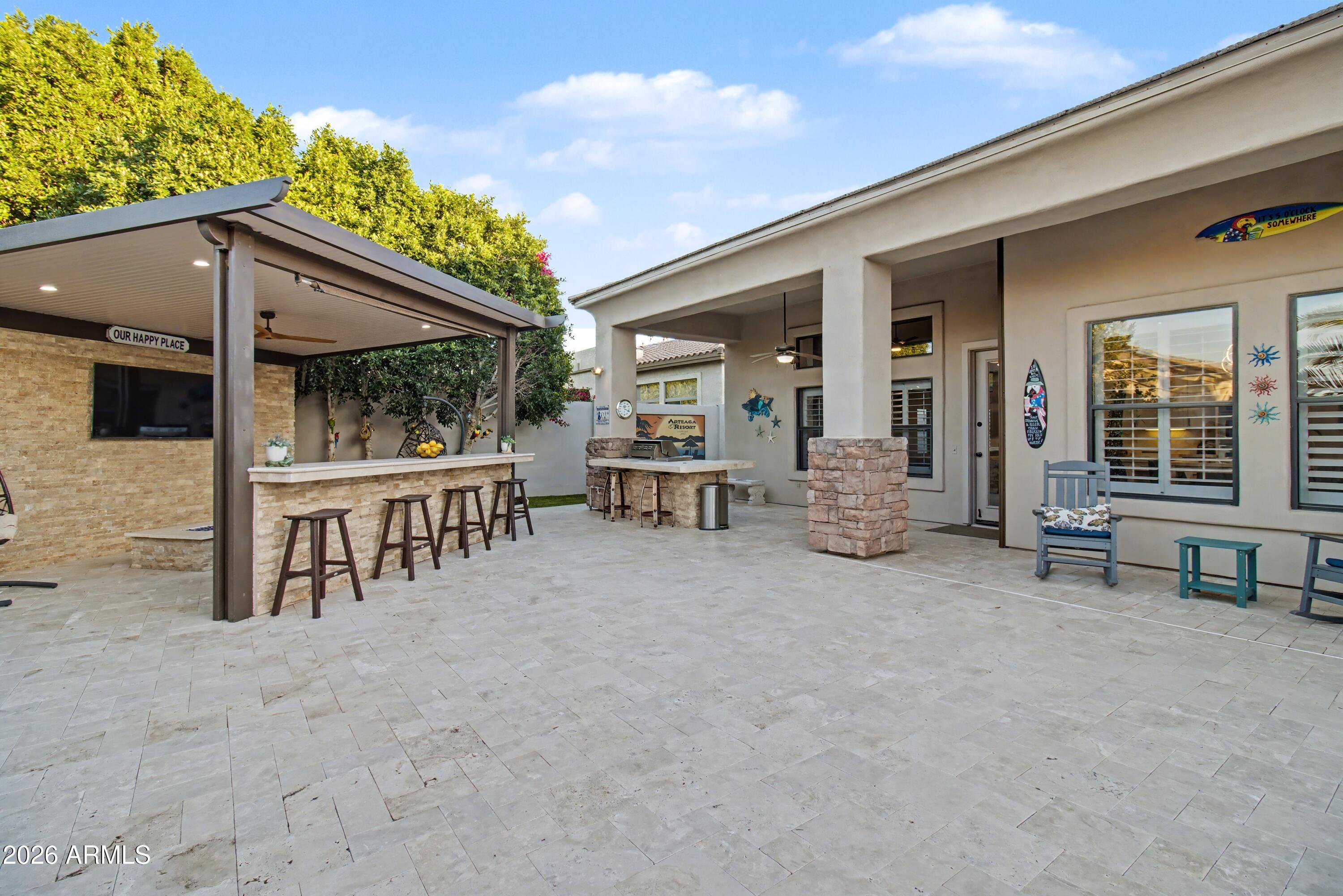 2184 West Weatherby Way Chandler, AZ 85286 - Photo 18 of 60 a view of a patio with table and chairs under an umbrella