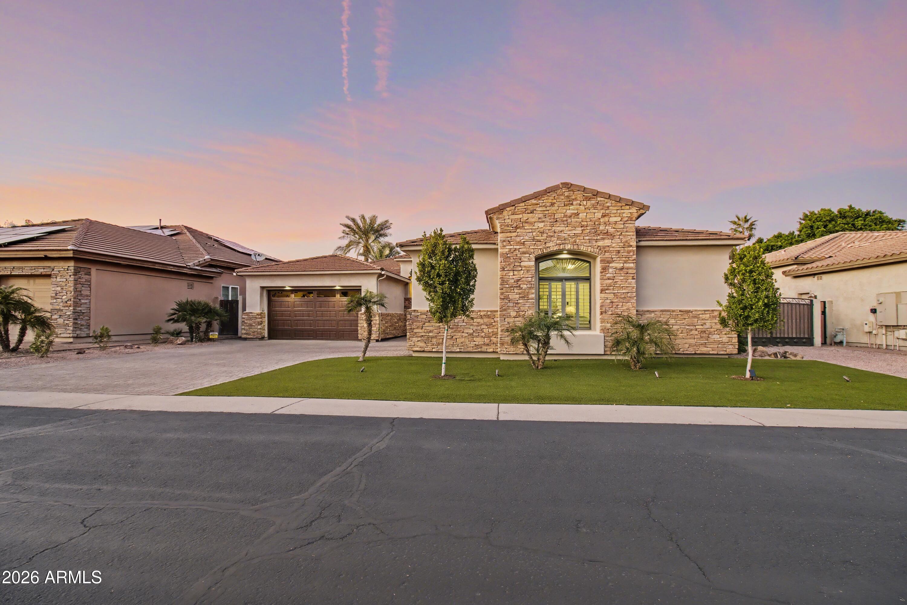 2184 West Weatherby Way Chandler, AZ 85286 - Photo 2 of 60 a front view of a house with a yard and garage