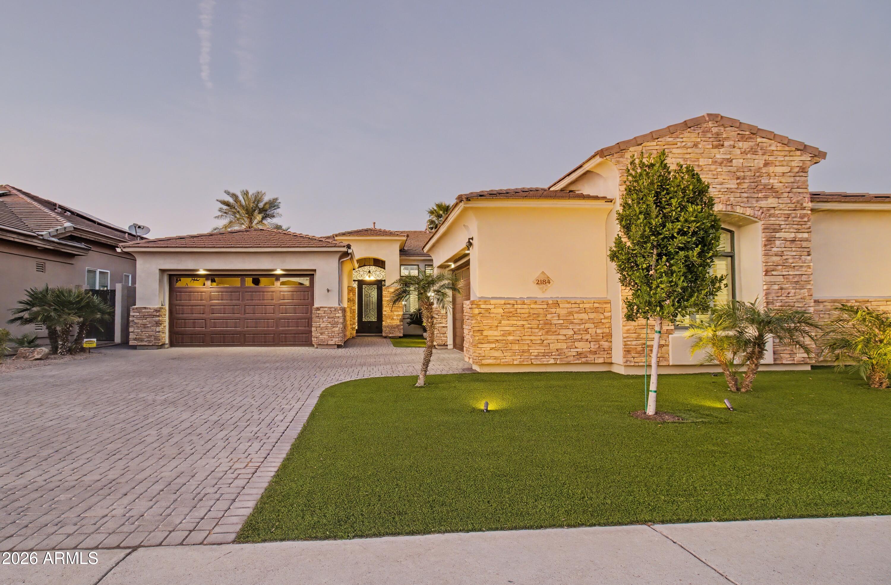 2184 West Weatherby Way Chandler, AZ 85286 - Photo 25 of 60 a front view of a house with a yard