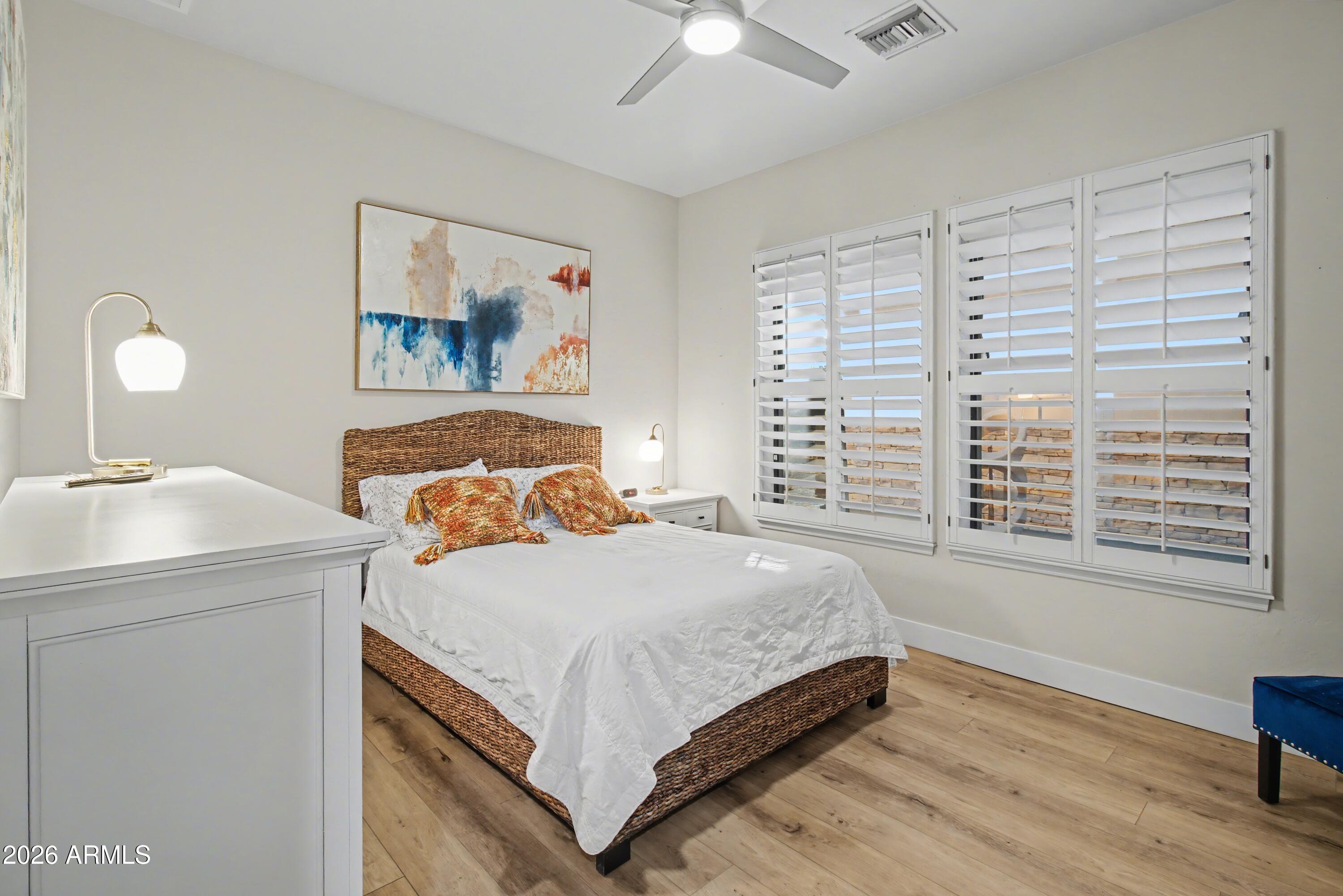 2184 West Weatherby Way Chandler, AZ 85286 - Photo 40 of 60 a bedroom with a bed and a table in it with window