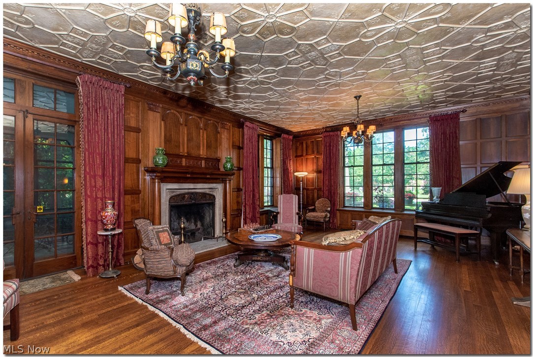 2467 Stratford Road Cleveland, OH 44118 - Photo 5 of 35 The living room with its imported fireplace and paneling from an English Manor house leads to a three season screened porch.