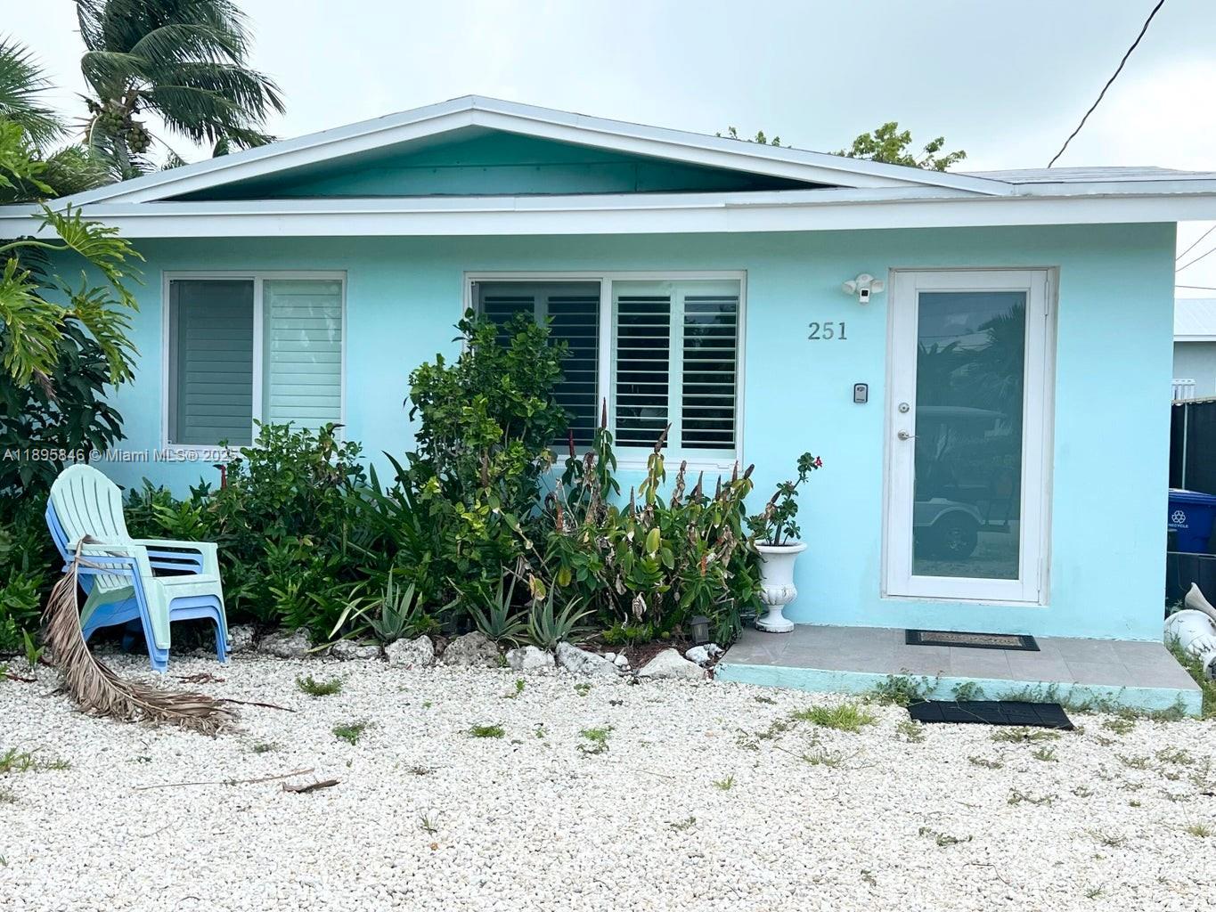 a couple of potted plants in front of a house