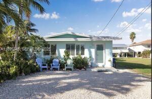 251 2nd Street Key Colony Beach, FL 33051 - Photo 3 of 20 a front view of a house with garden