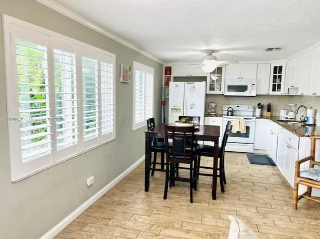 a view of a dining room with furniture and a window