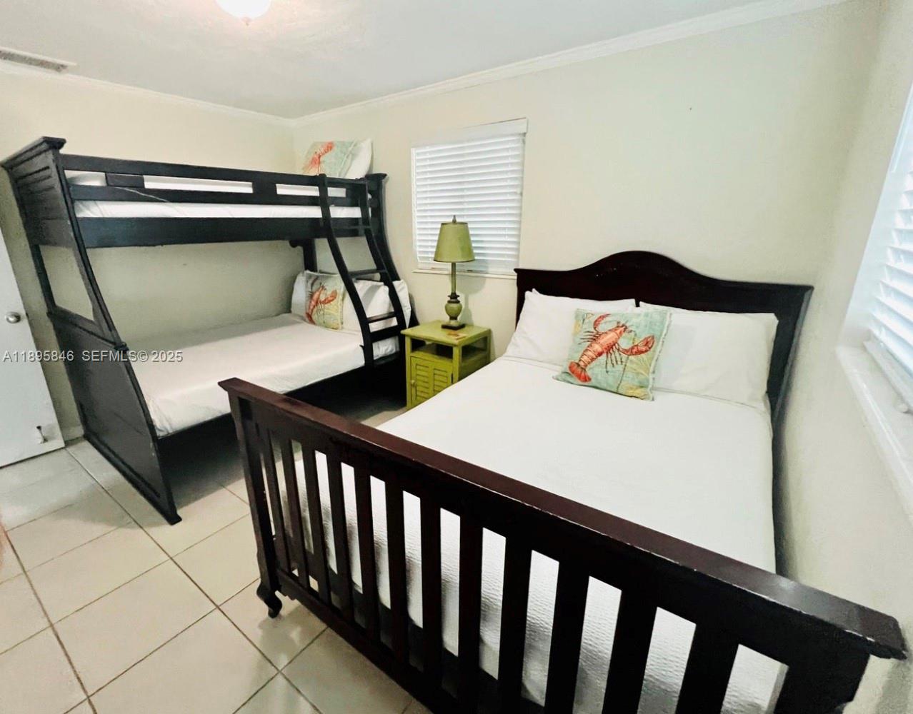251 2nd Street Key Colony Beach, FL 33051 - Photo 10 of 20 a bedroom with furniture and a window