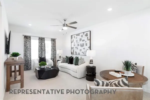 a living room with furniture potted plant and a window