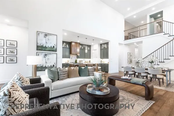 a living room with furniture and a dining table with kitchen view