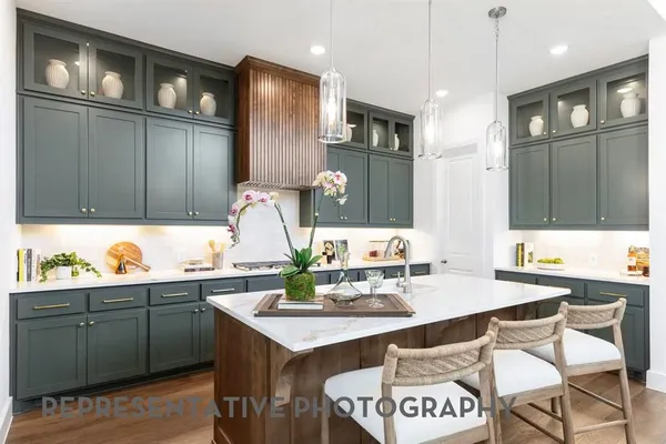 a kitchen with a sink cabinets and wooden floor