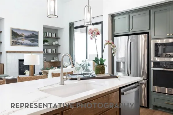 a kitchen with stainless steel appliances granite countertop a refrigerator and a stove