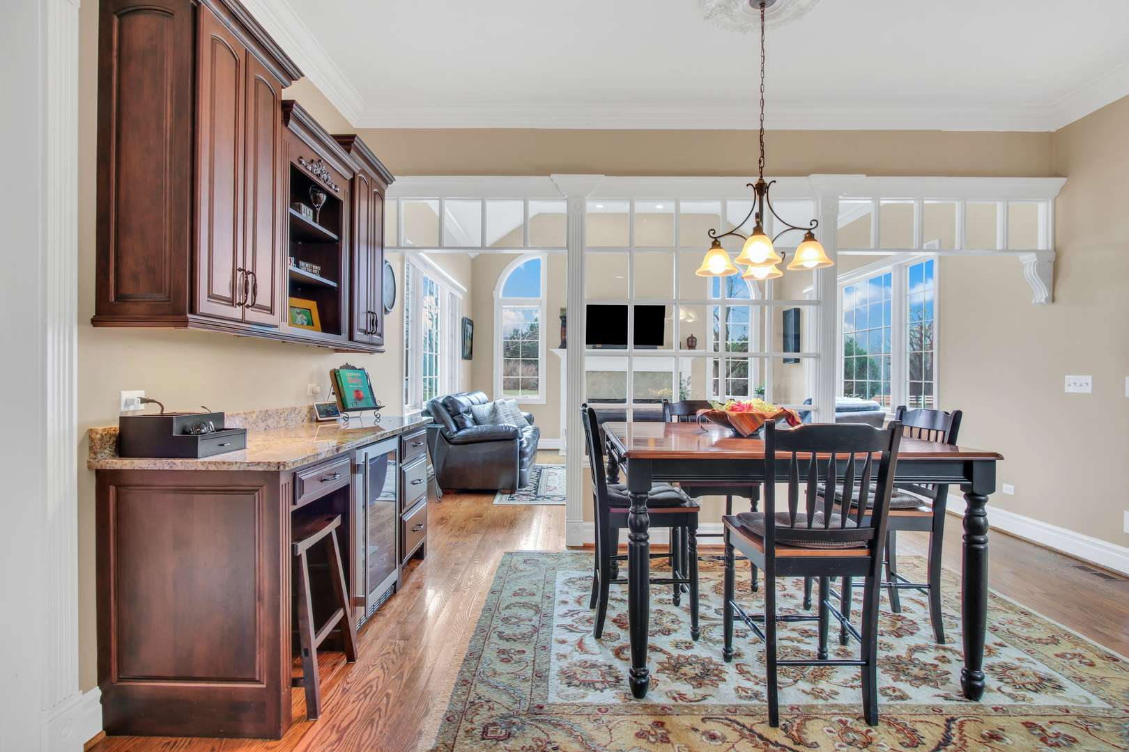 17451 Bridle Trail Road Gurnee, IL 60031 - Photo 13 of 121 a view of a dining room with furniture a chandelier and wooden floor